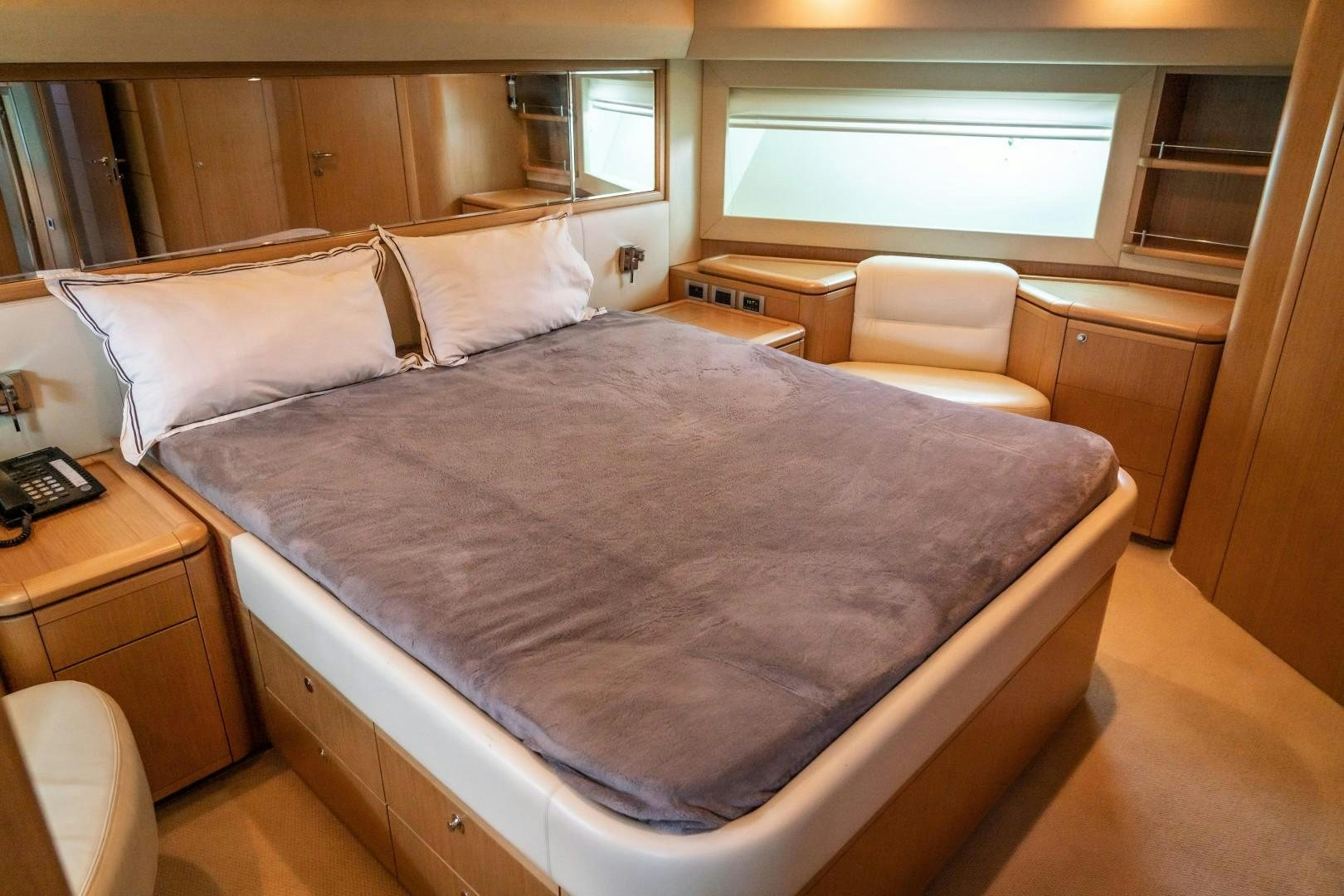 a bed with a white comforter aboard FORTIS II Yacht for Sale