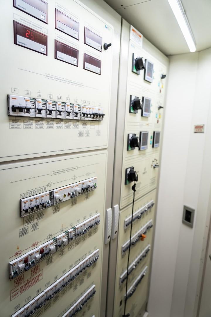 a wall with pictures on it aboard FORTIS II Yacht for Sale