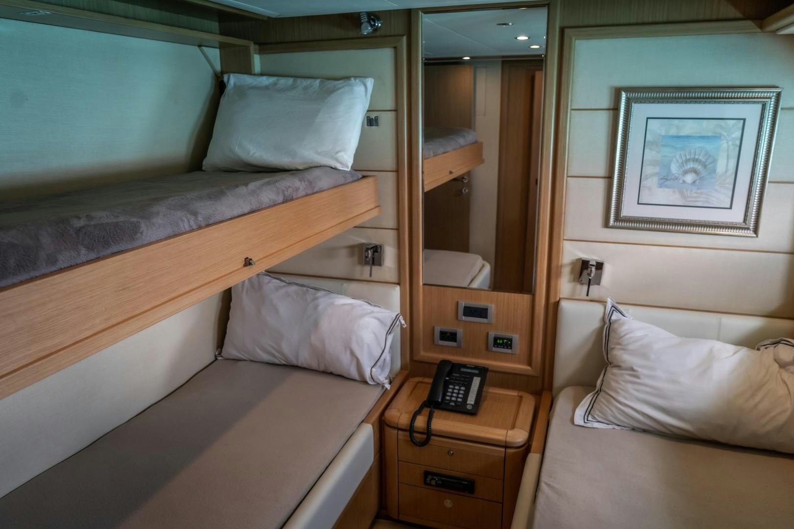 a bed with a phone on it aboard FORTIS II Yacht for Sale