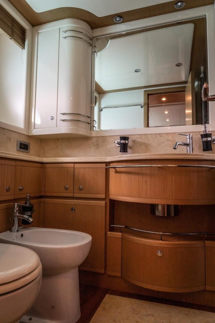 a bathroom with wooden cabinets aboard FORTIS II Yacht for Sale