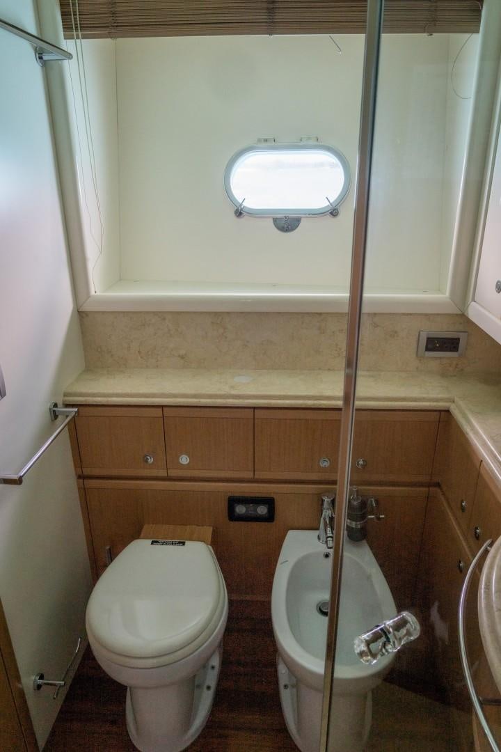 a toilet with a wooden pole aboard FORTIS II Yacht for Sale