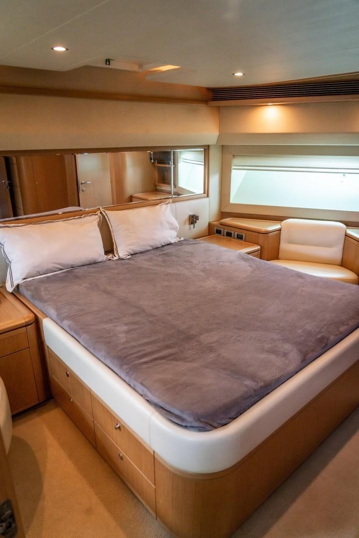 a bed with a purple comforter aboard FORTIS II Yacht for Sale