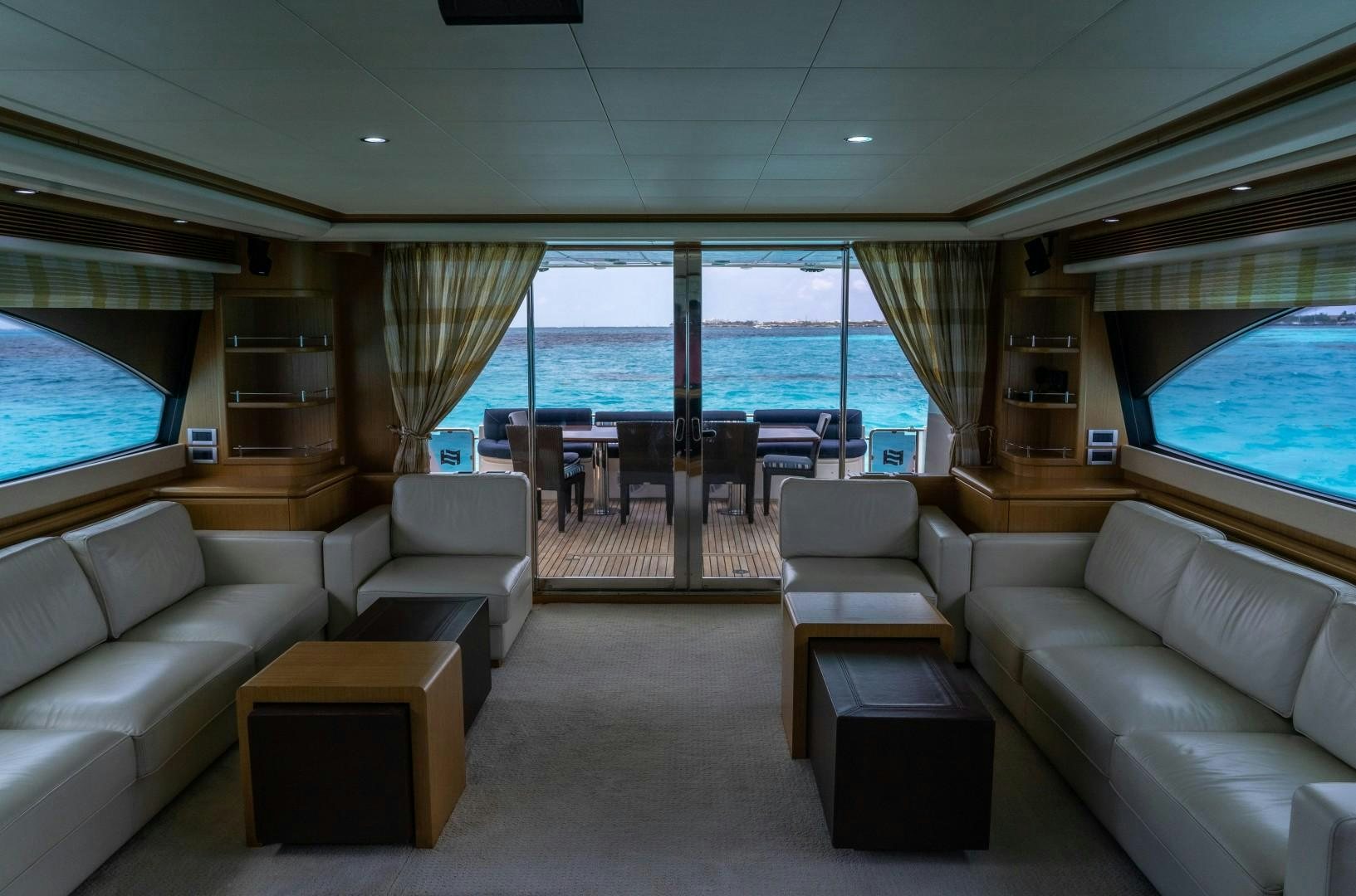 a living room with a large window aboard FORTIS II Yacht for Sale