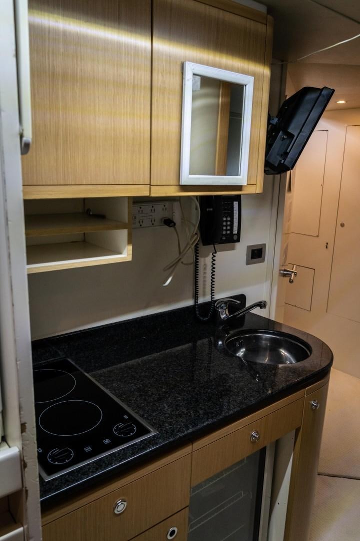 a kitchen with a black countertop aboard FORTIS II Yacht for Sale