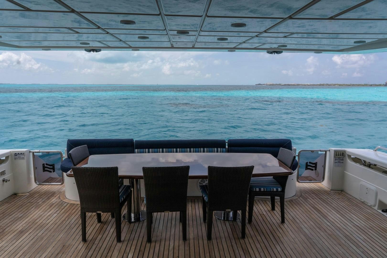 a table and chairs on a deck aboard FORTIS II Yacht for Sale