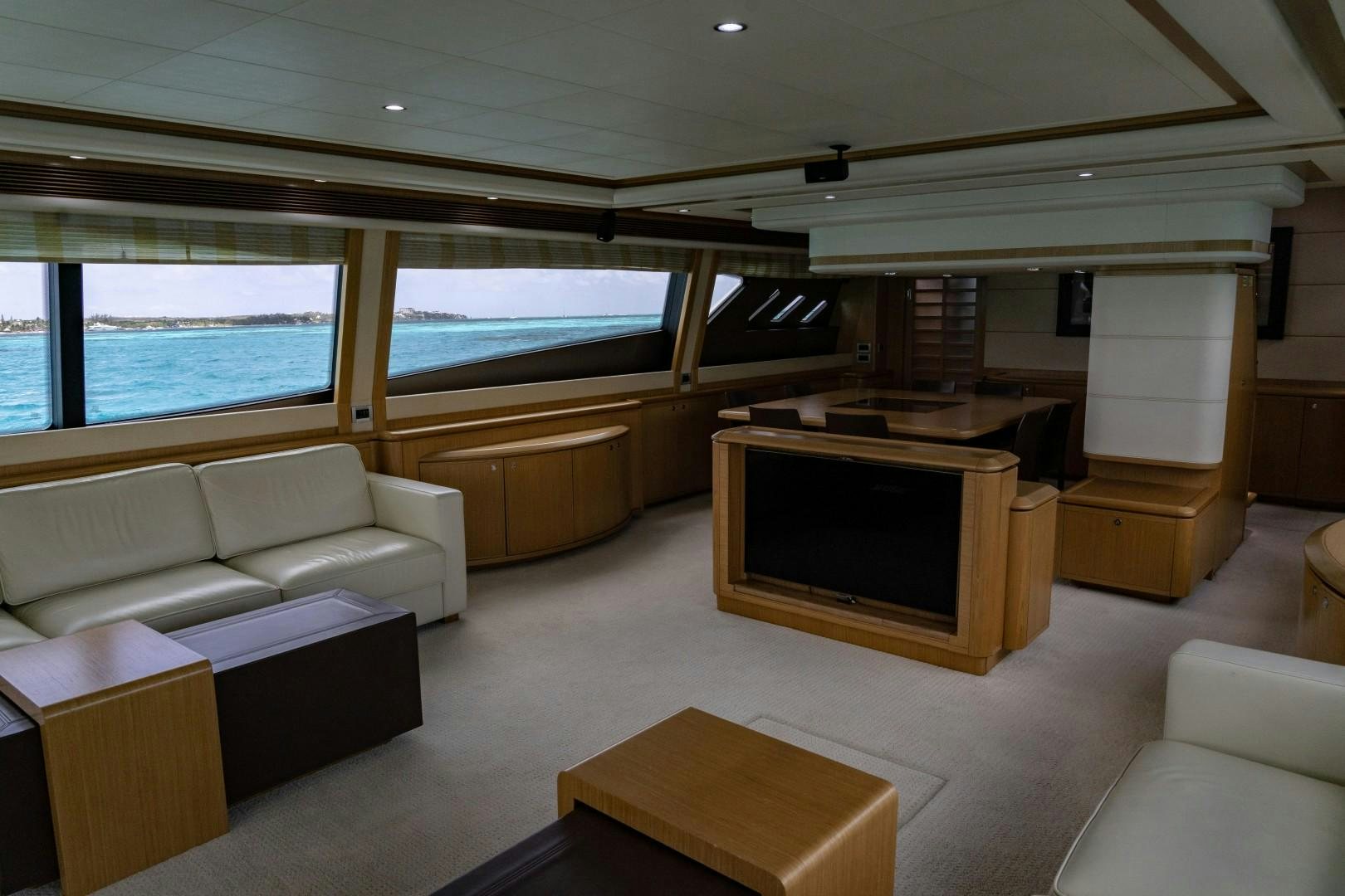 a living room with a tv and sofas aboard FORTIS II Yacht for Sale
