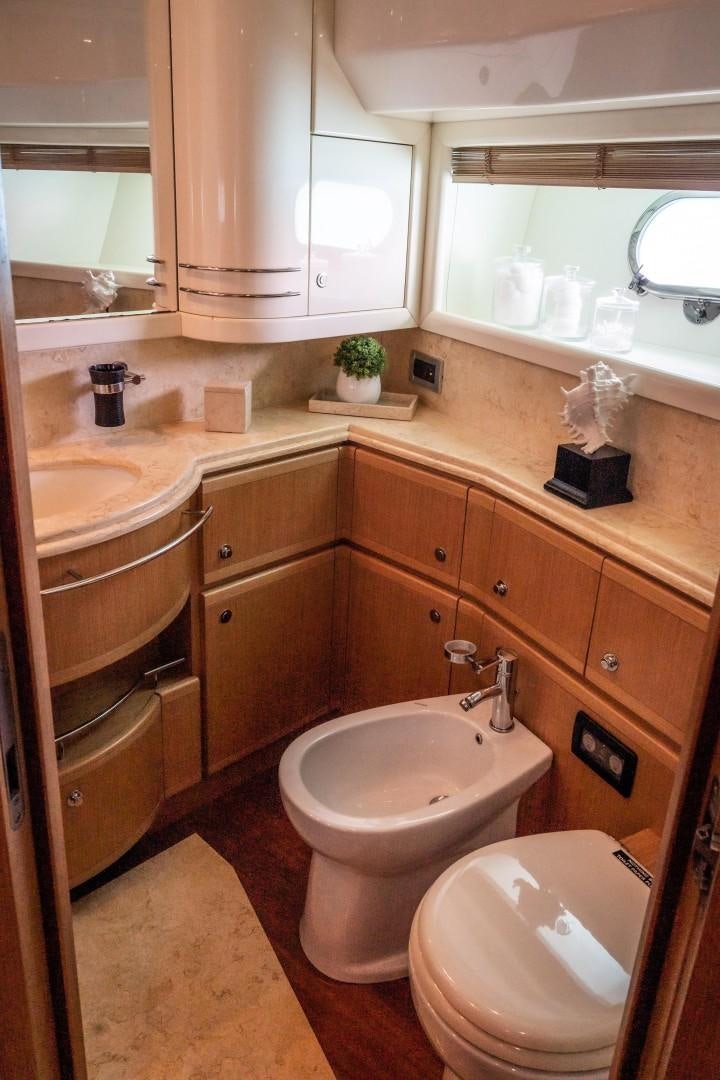 a bathroom with a toilet and sink aboard FORTIS II Yacht for Sale