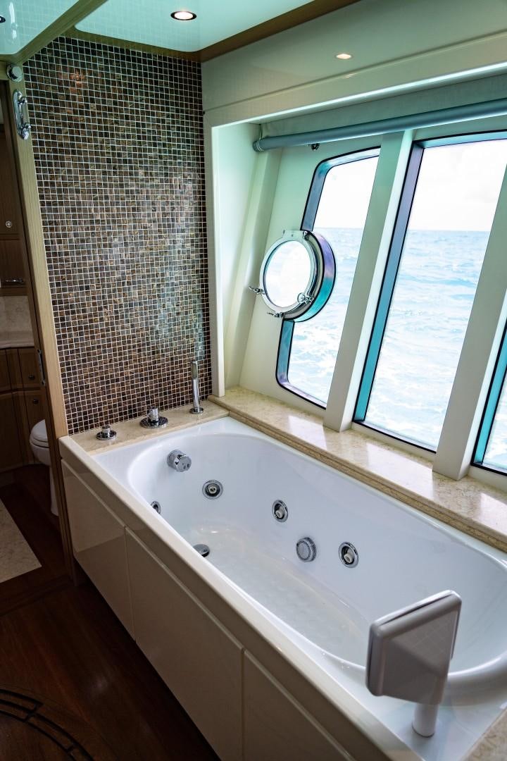 a bathroom with a tub and a sink aboard FORTIS II Yacht for Sale