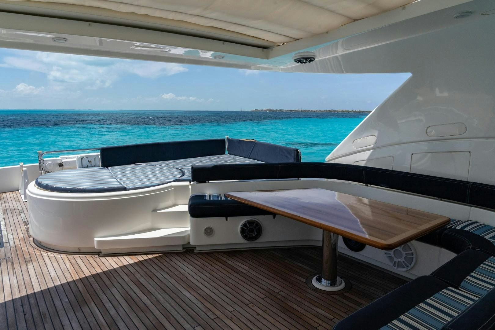 a deck with a pool and a deck with a view of the ocean aboard FORTIS II Yacht for Sale