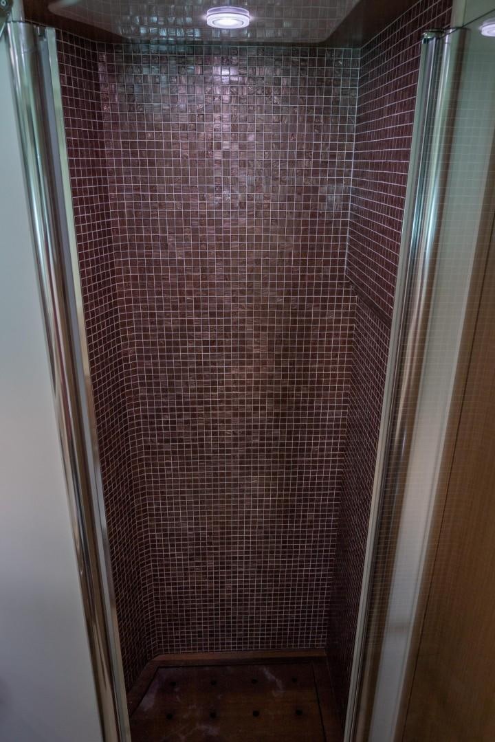 a shower with a tile floor aboard FORTIS II Yacht for Sale