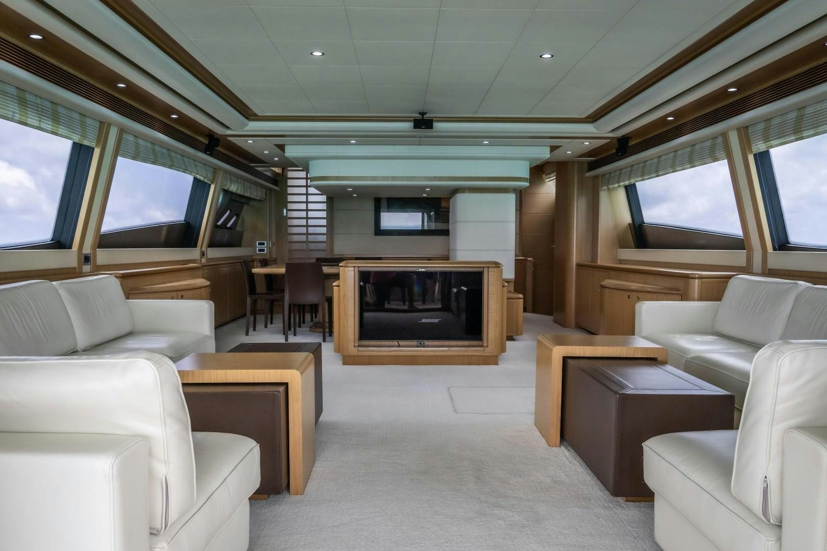 a living room with a fireplace aboard FORTIS II Yacht for Sale