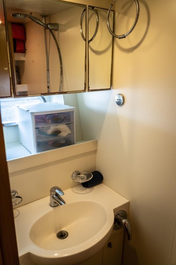 a bathroom with a mirror and a sink aboard FORTIS II Yacht for Sale