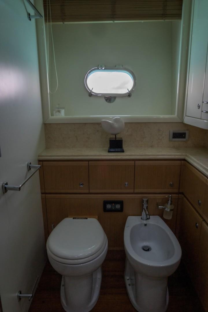 a bathroom with a toilet and a sink aboard FORTIS II Yacht for Sale