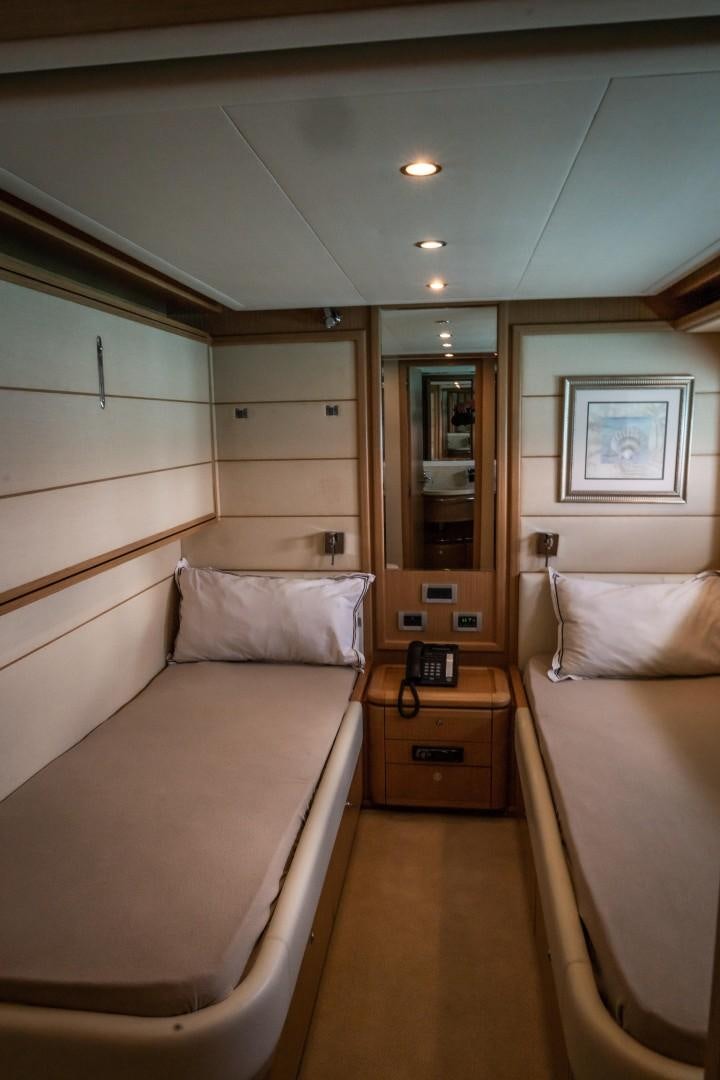 a room with a bed and a mirror aboard FORTIS II Yacht for Sale