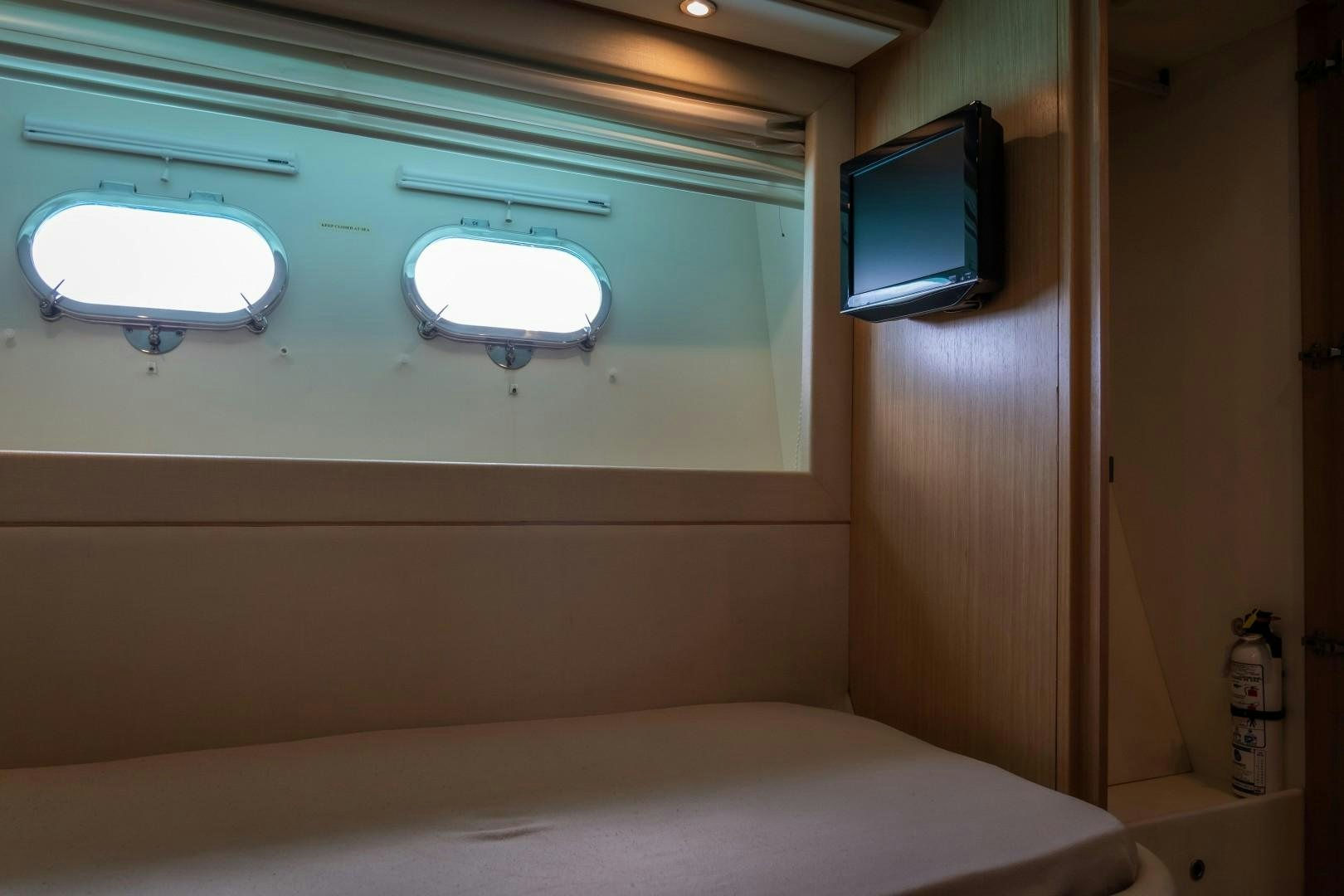 a room with a bed and a television aboard FORTIS II Yacht for Sale