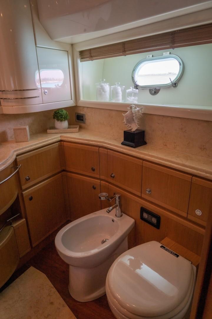 a bathroom with a toilet and a sink aboard FORTIS II Yacht for Sale