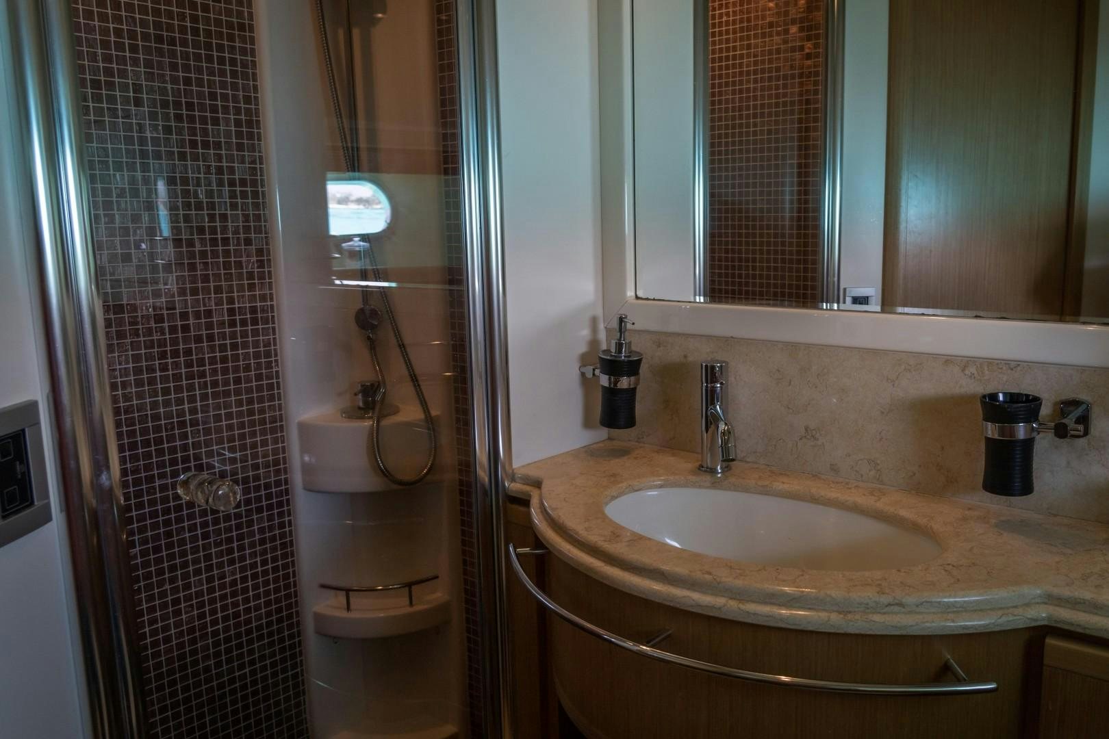 a bathroom with a sink and a mirror aboard FORTIS II Yacht for Sale