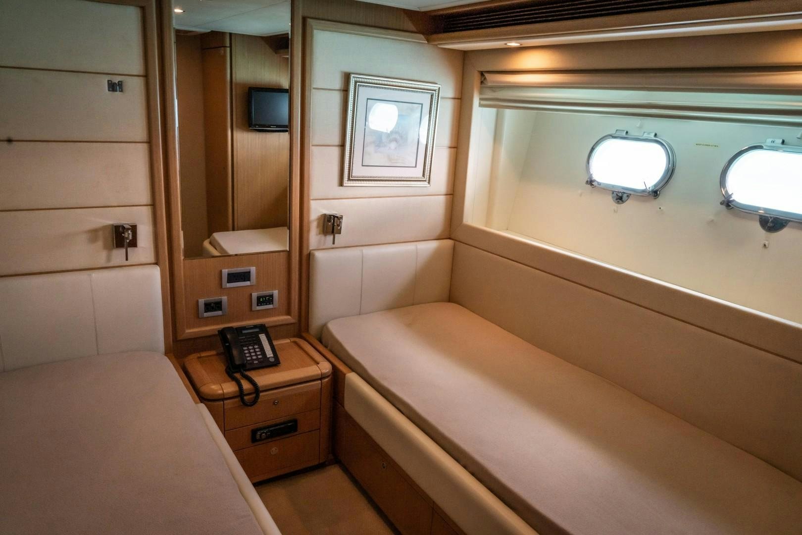 a room with a bed and a phone aboard FORTIS II Yacht for Sale