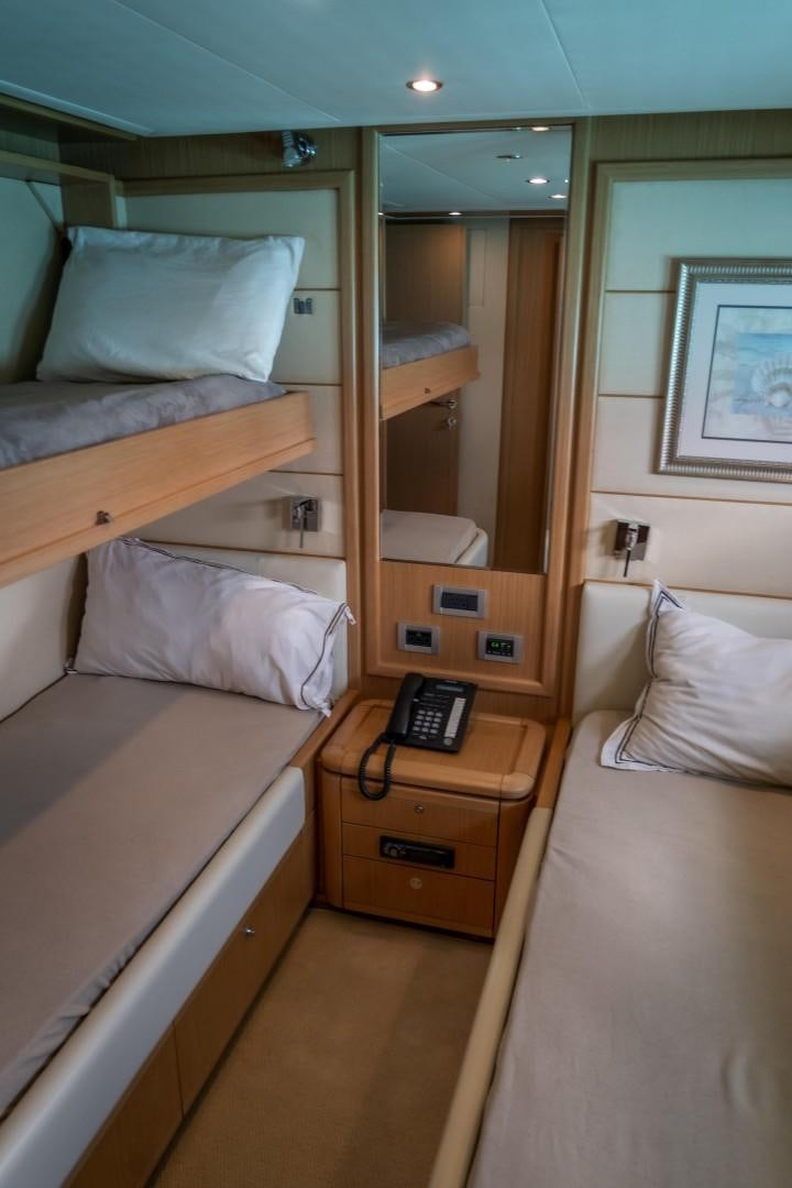 a bed with a phone on it aboard FORTIS II Yacht for Sale