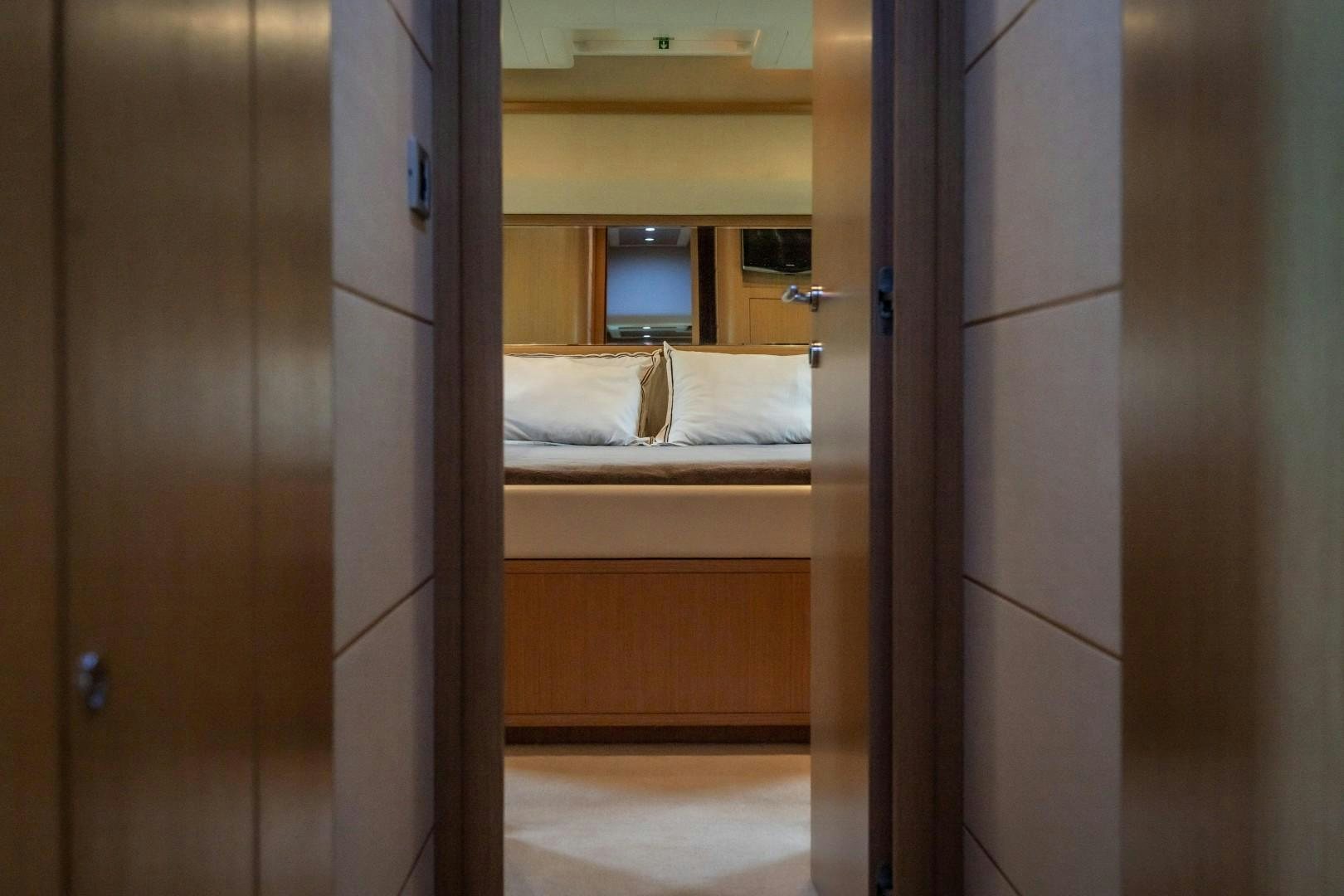 a room with a bed and a mirror aboard FORTIS II Yacht for Sale