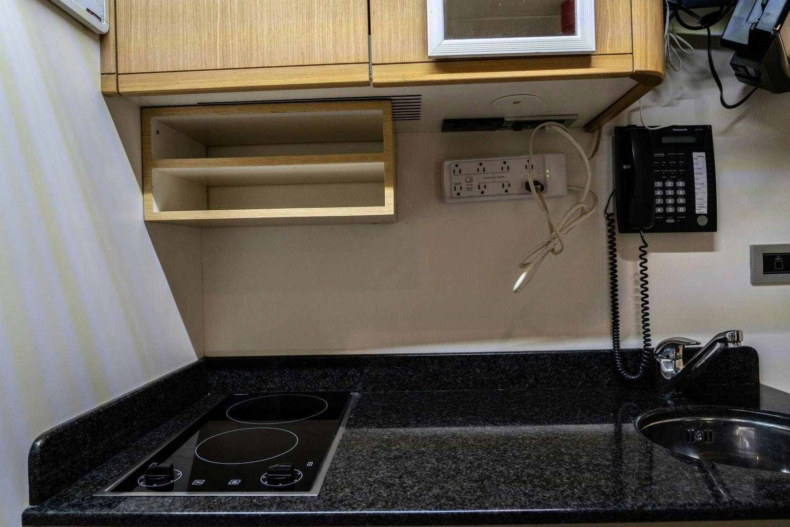 a kitchen counter with a stove and sink aboard FORTIS II Yacht for Sale