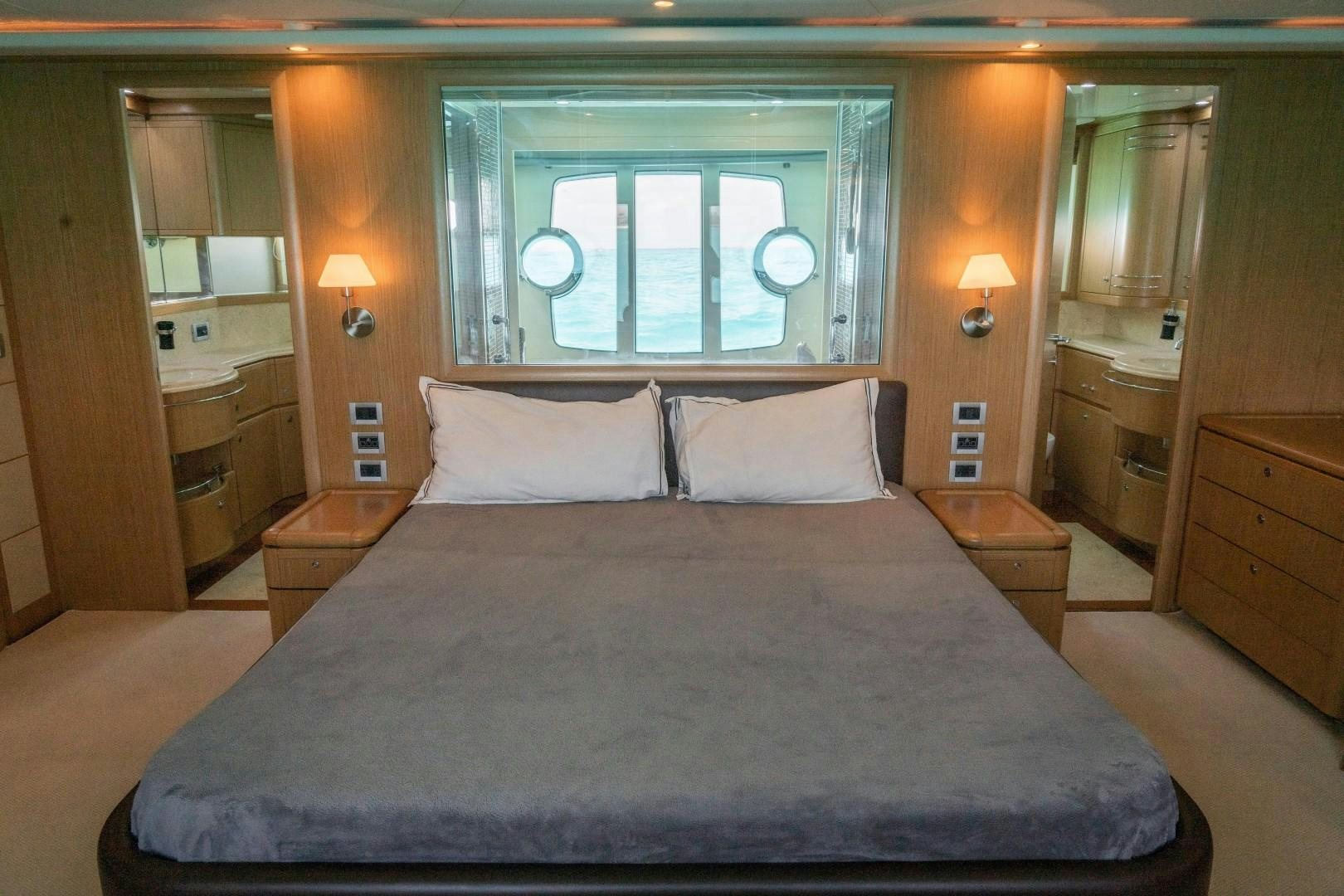 a bed with white sheets aboard FORTIS II Yacht for Sale