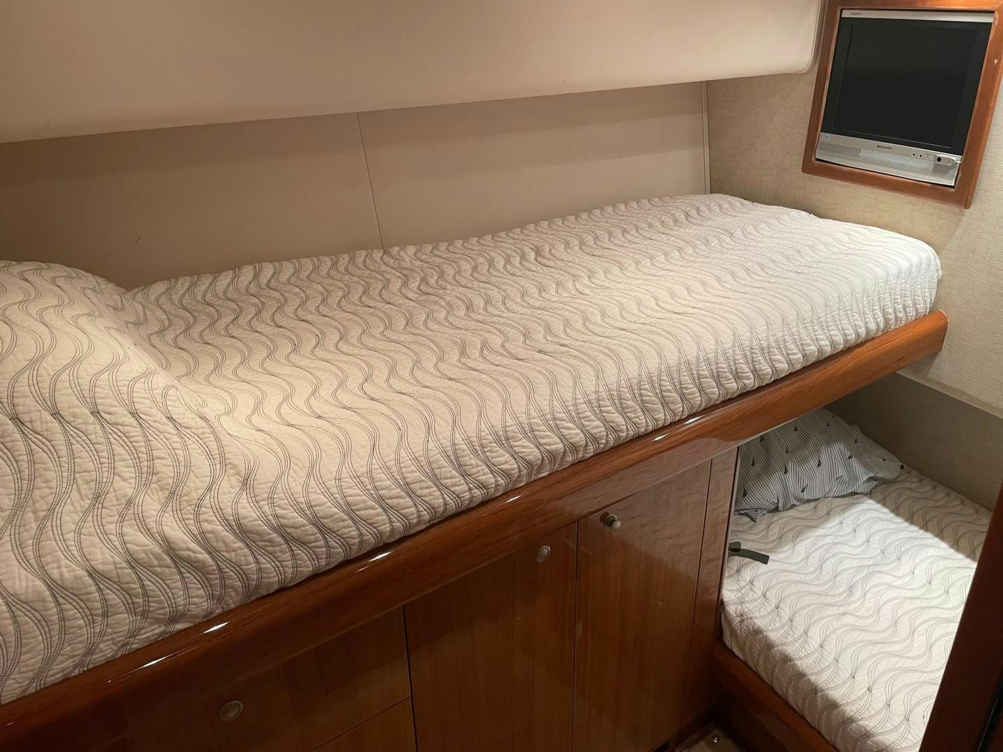 a bed with a white comforter aboard BANDIT Yacht for Sale
