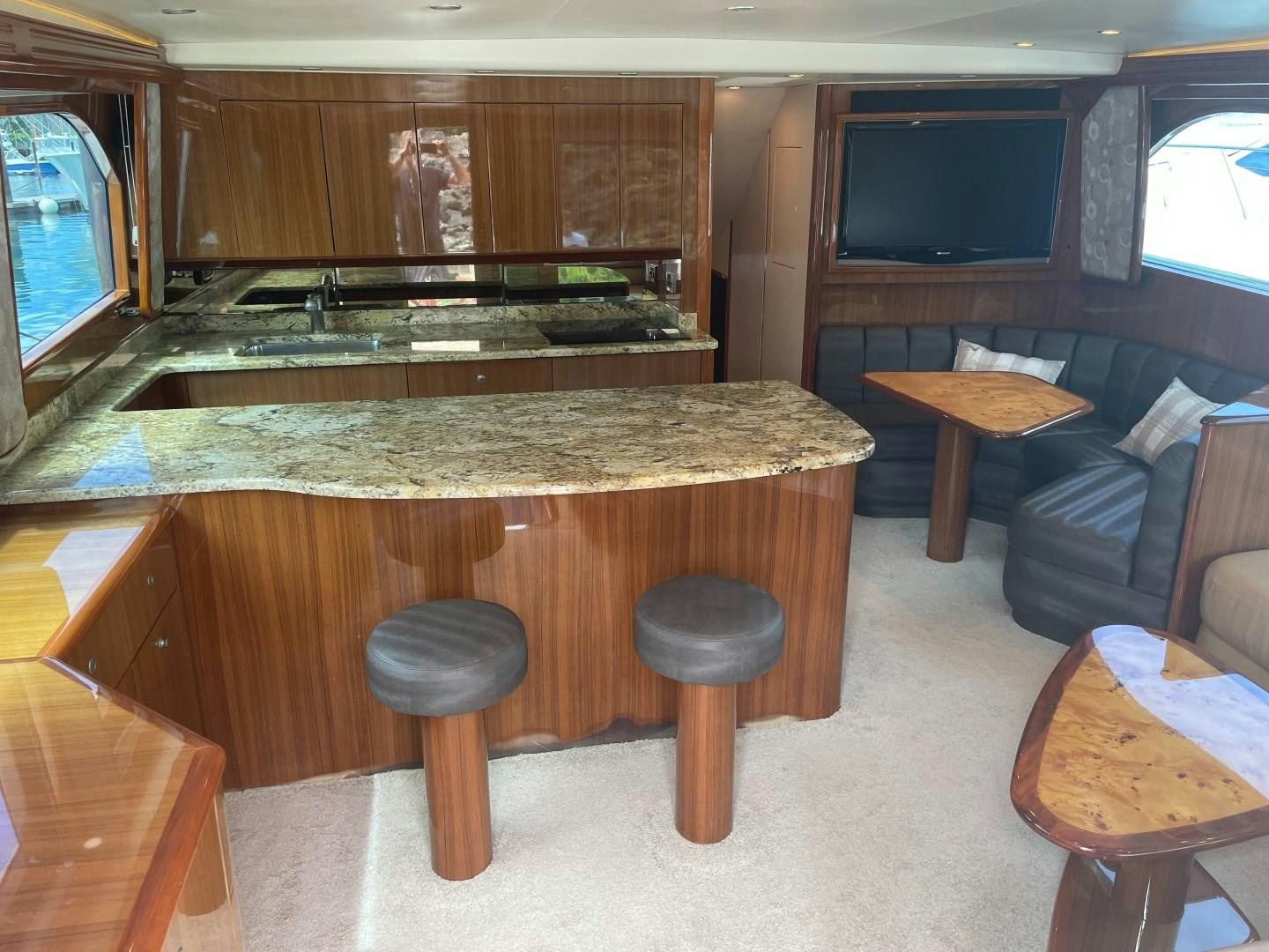 a kitchen with a bar and stools aboard BANDIT Yacht for Sale