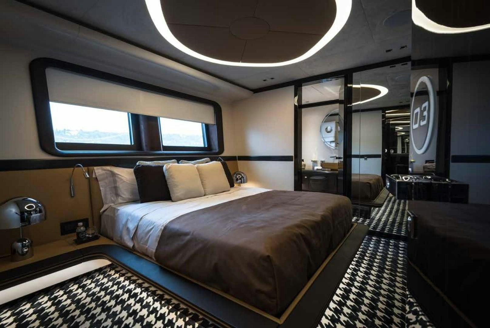 a room with a bed and a window aboard GTT 115 Yacht for Sale
