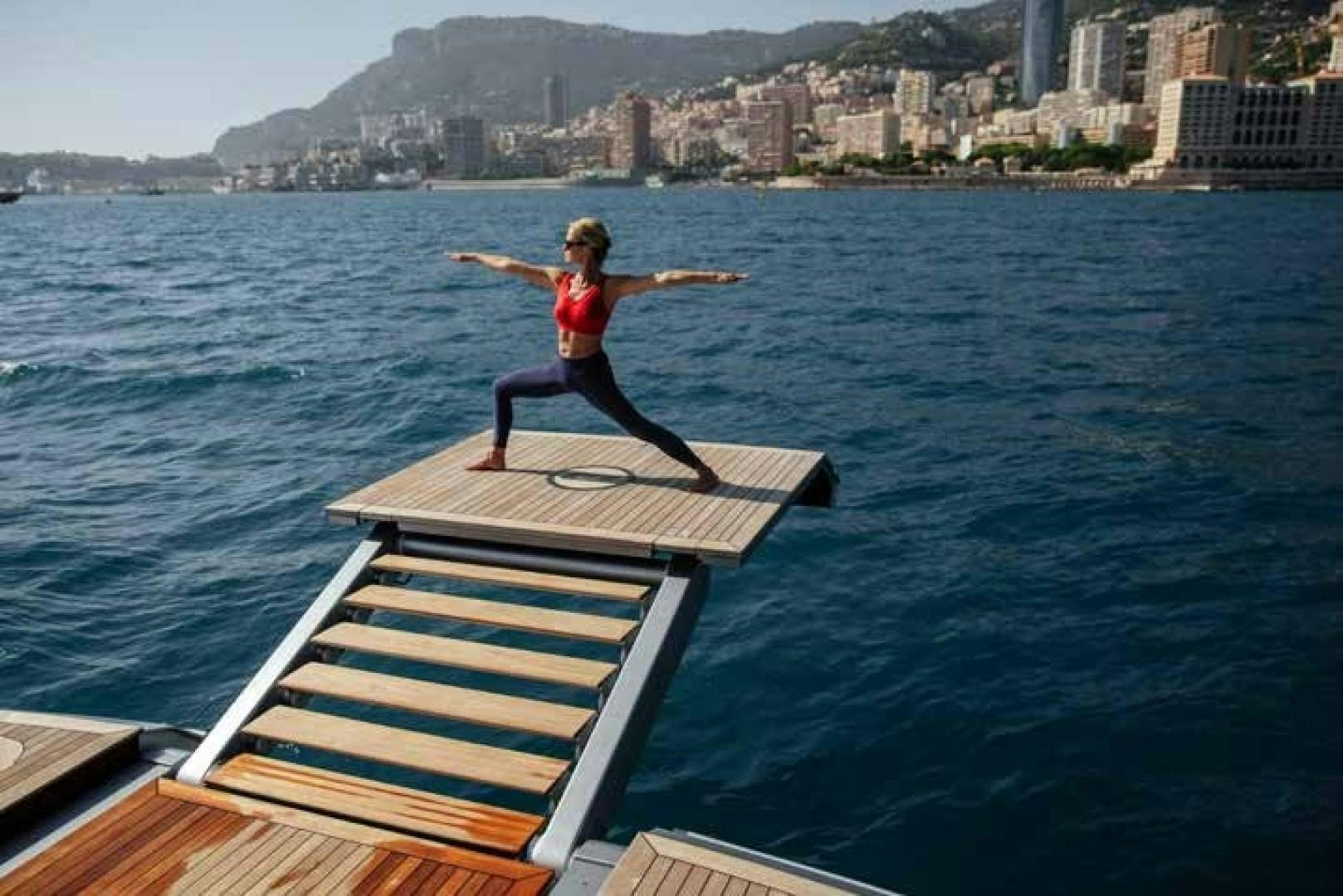 a child on a platform in the water aboard GTT 115 Yacht for Sale