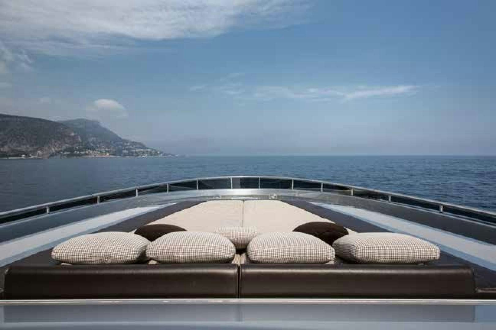 a row of seashells on a wood table by a body of water aboard GTT 115 Yacht for Sale