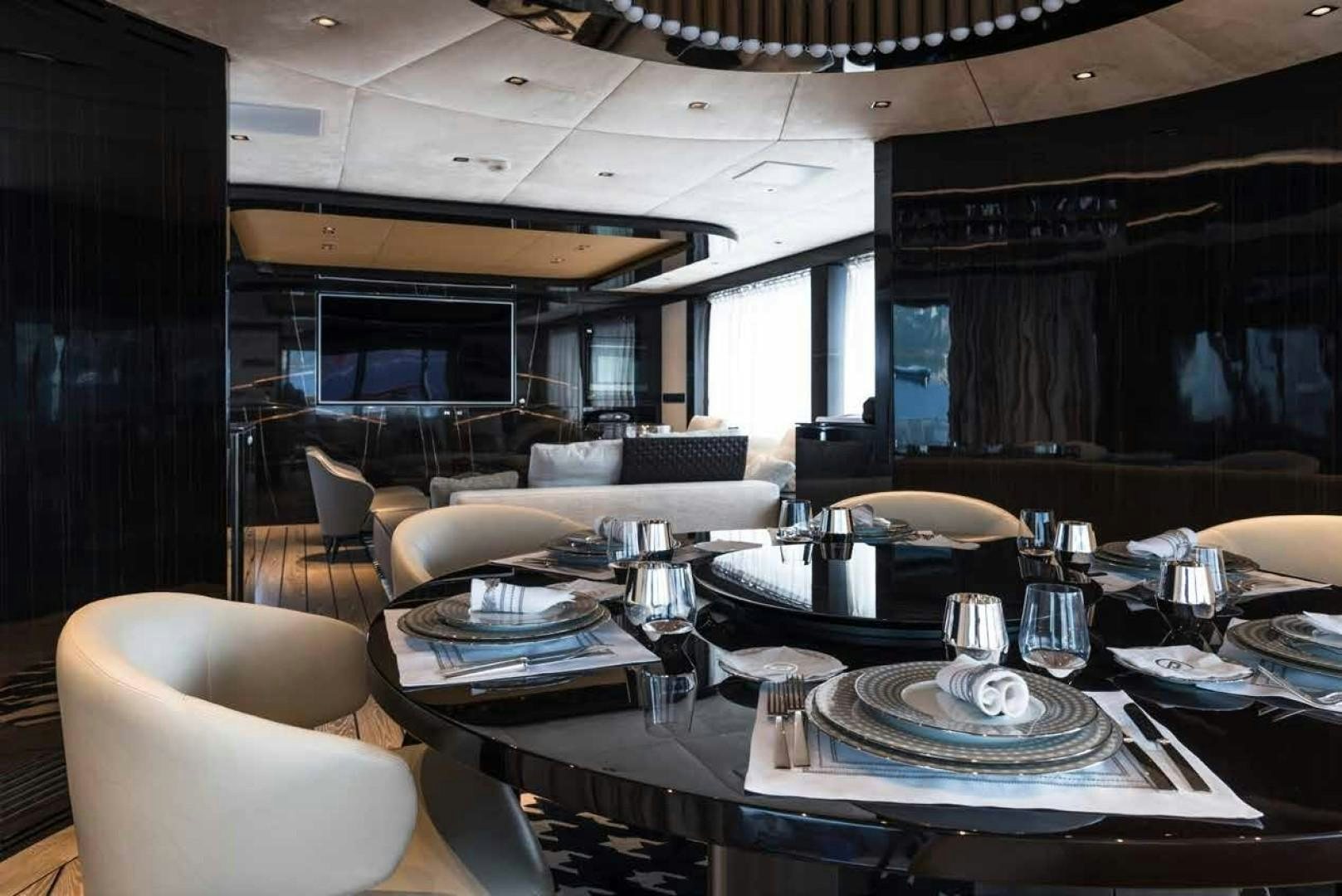 a large room with a table and chairs aboard GTT 115 Yacht for Sale
