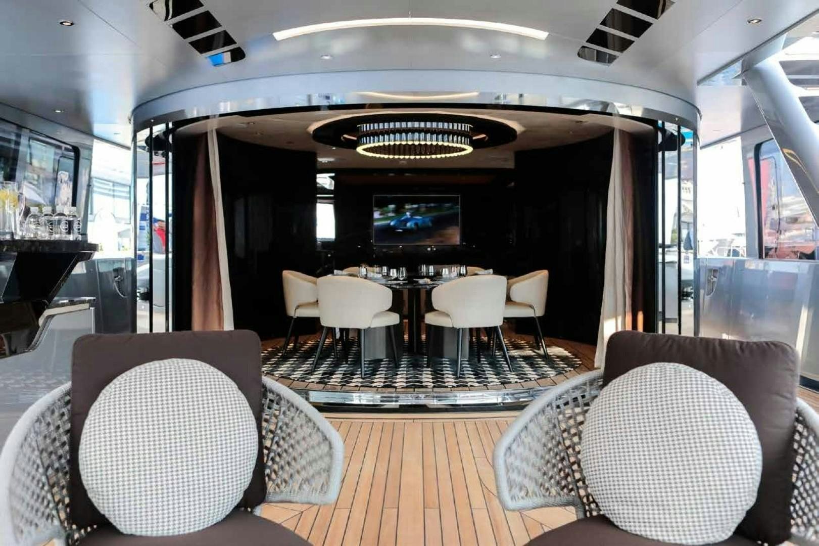 a room with chairs and tables aboard GTT 115 Yacht for Sale
