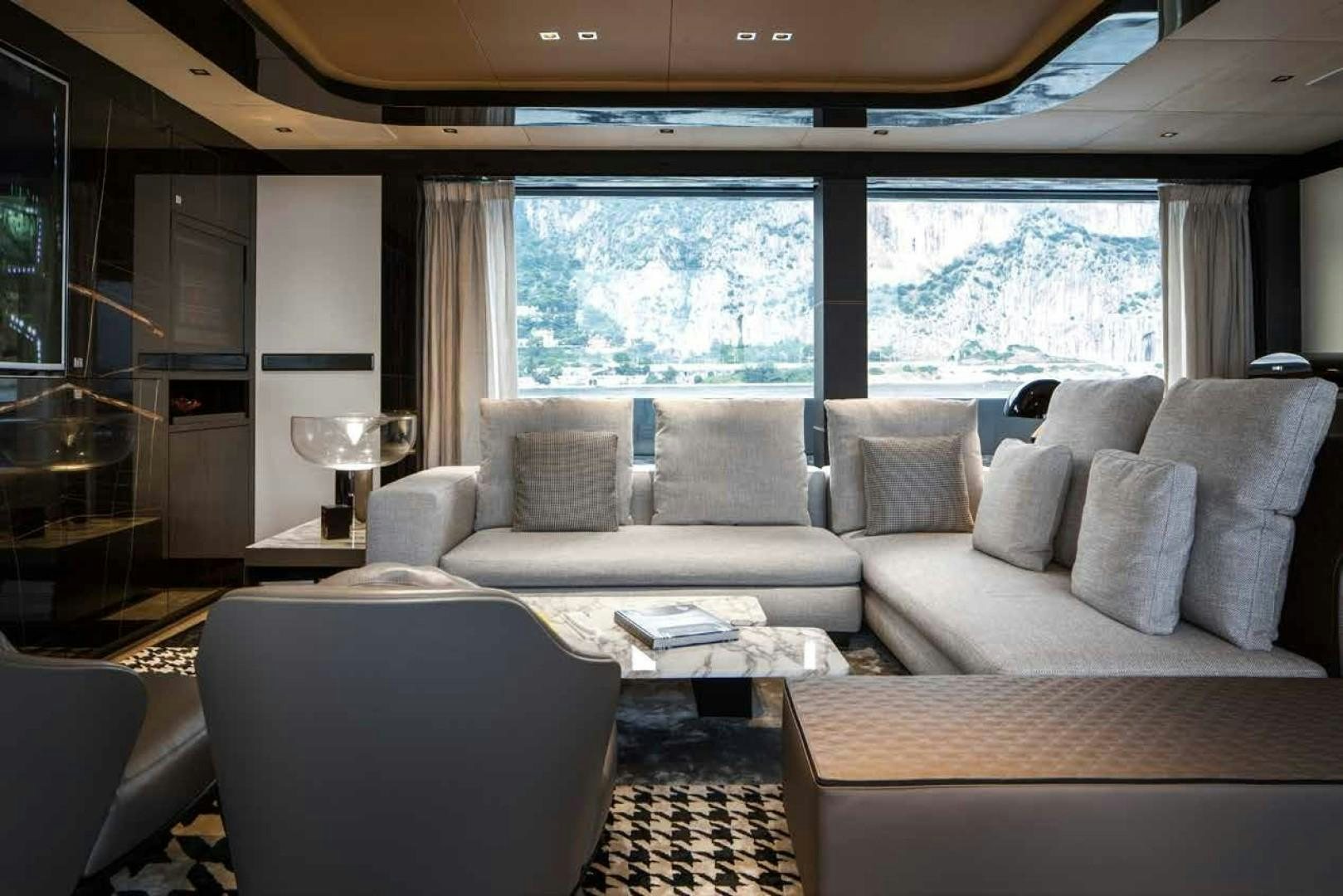 a living room with a large window aboard GTT 115 Yacht for Sale