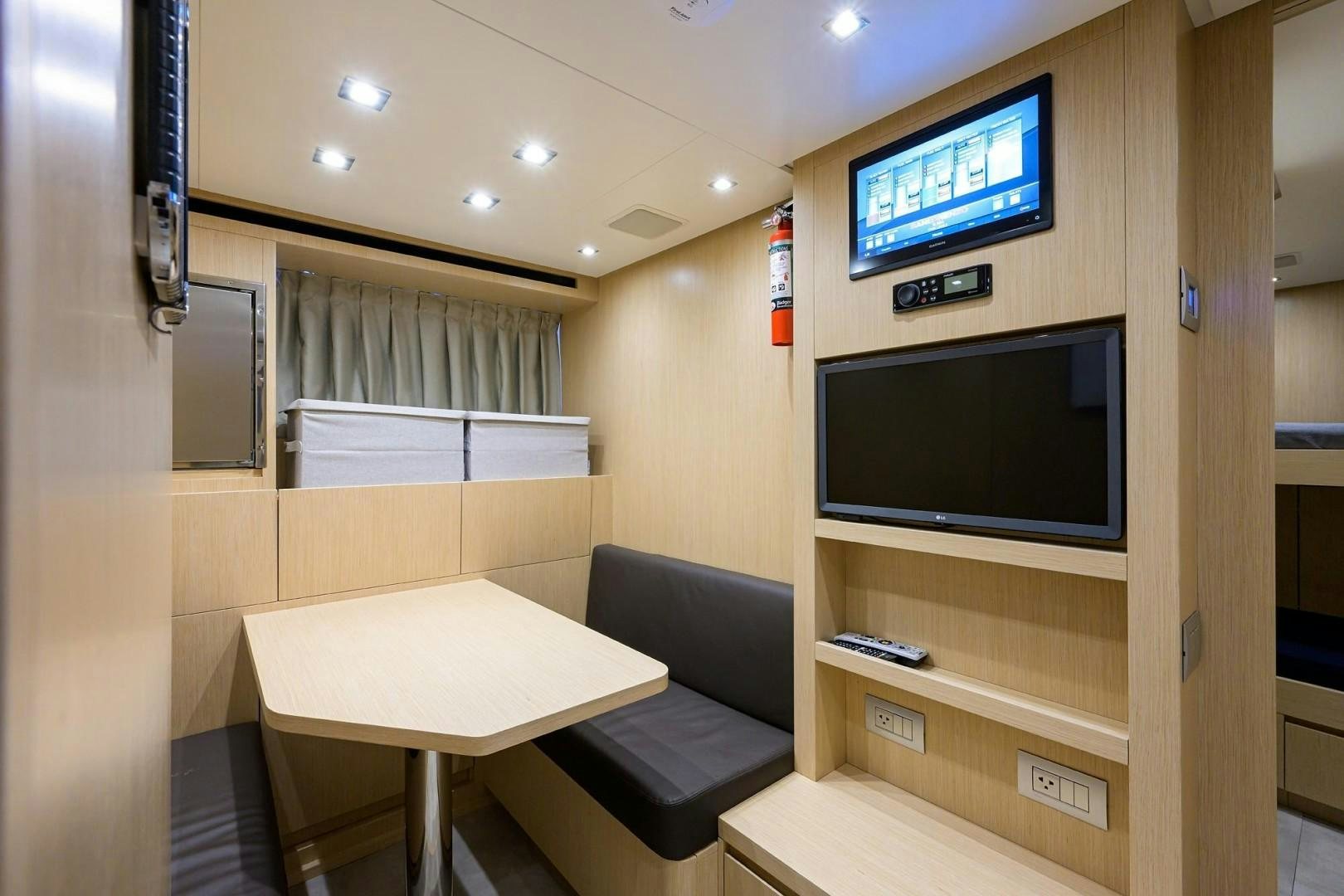 a room with a tv and a chair aboard NINIPOP XL Yacht for Sale