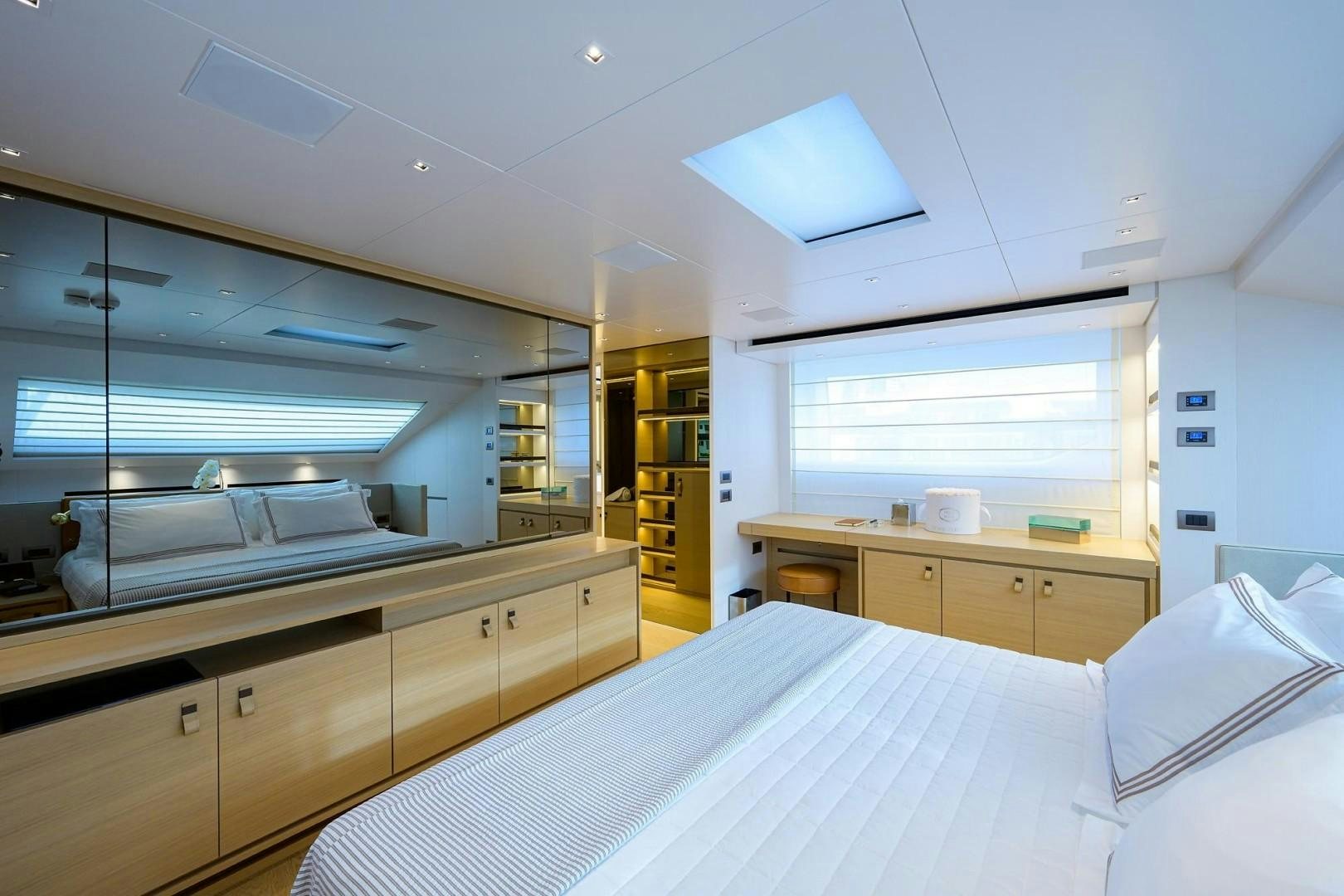 a bedroom with a large window aboard NINIPOP XL Yacht for Sale