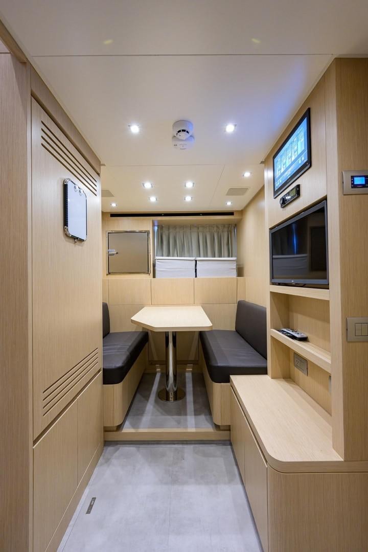 a room with a table and chairs aboard NINIPOP XL Yacht for Sale