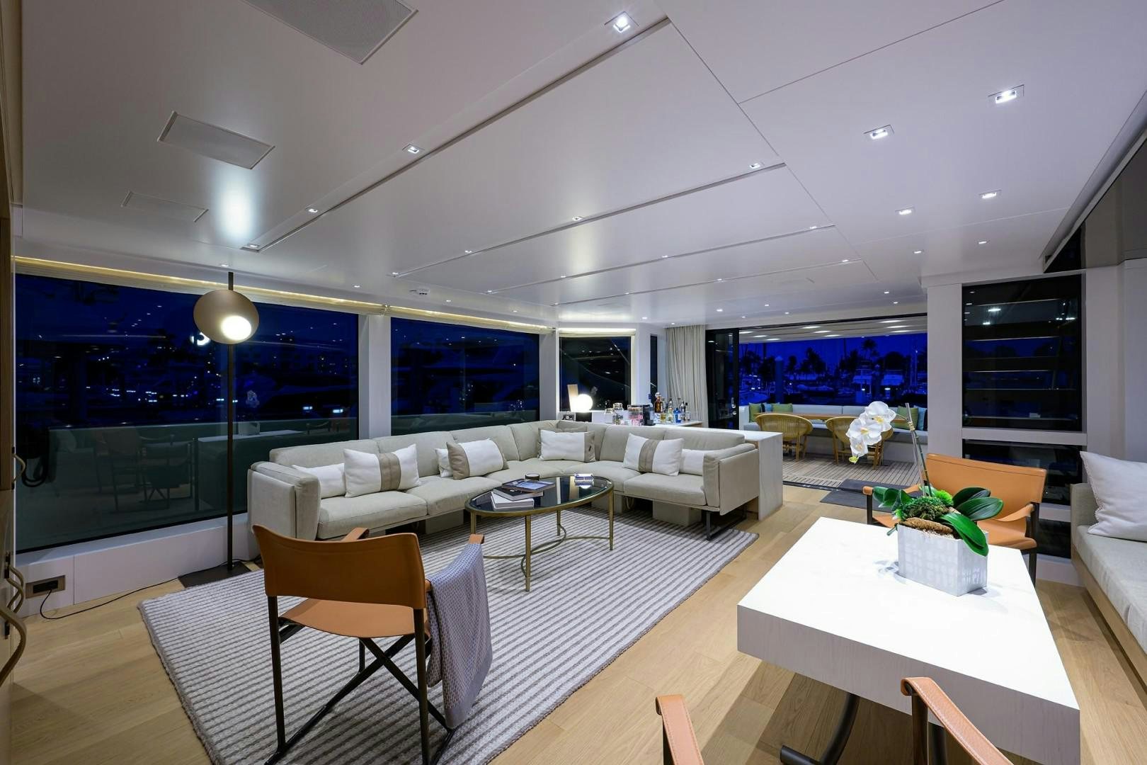a living room with a large white sofa and a large screen aboard NINIPOP XL Yacht for Sale