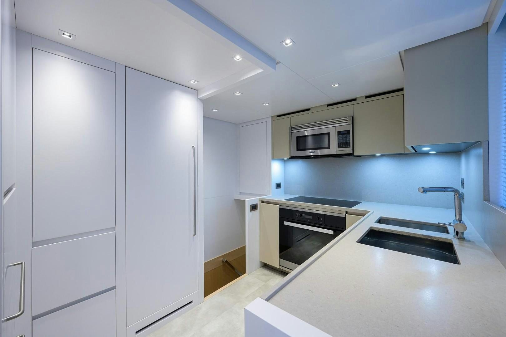 a kitchen with white cabinets aboard NINIPOP XL Yacht for Sale