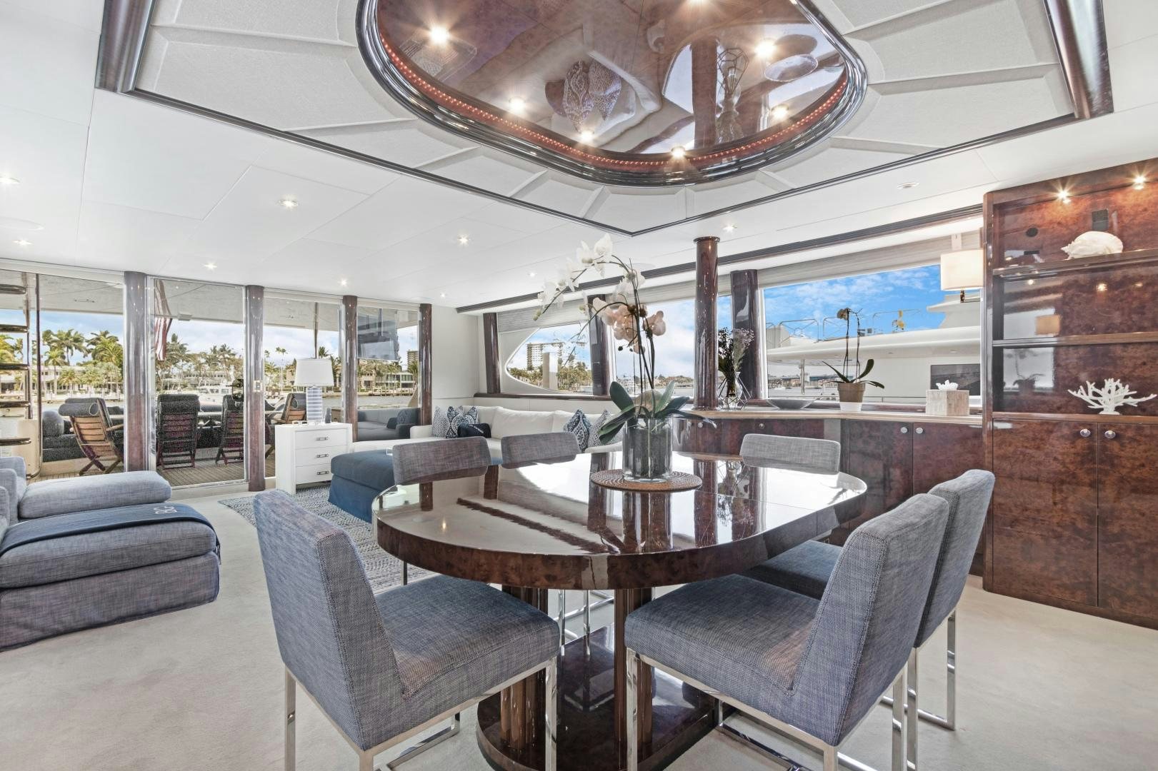 a large room with a table and chairs aboard BELLA GIORNATA Yacht for Sale