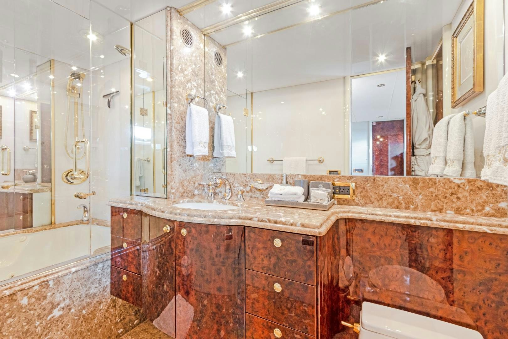 a bathroom with a large marble countertop aboard BELLA GIORNATA Yacht for Sale