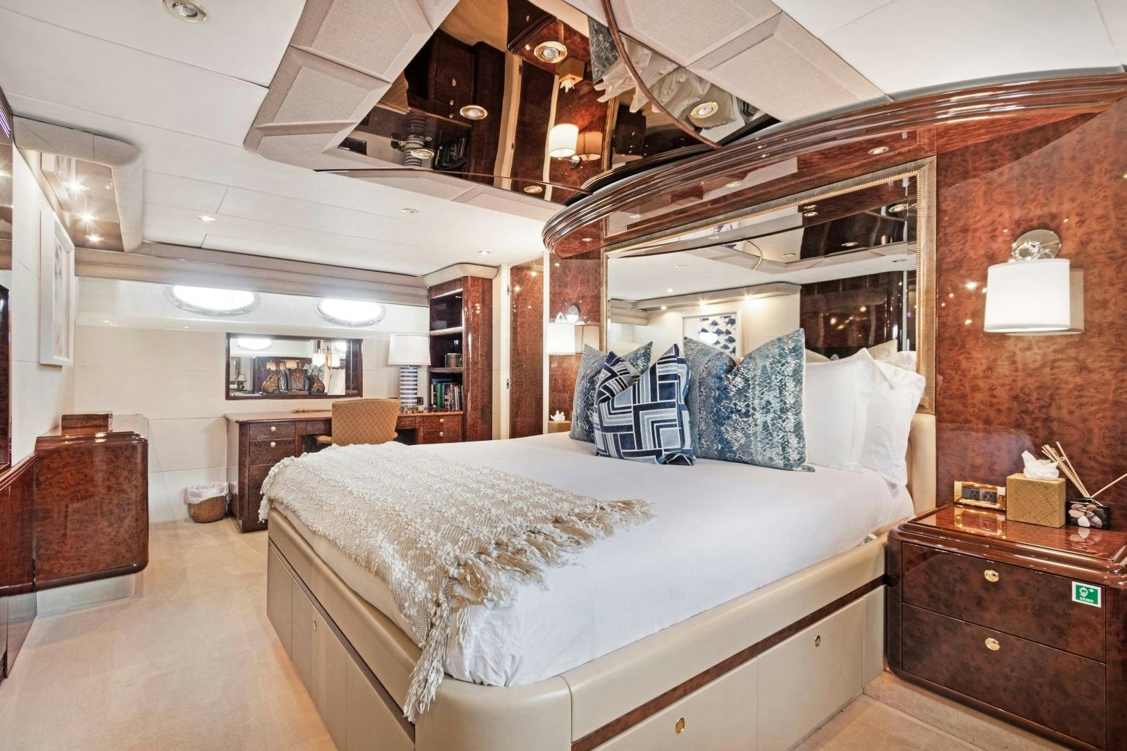 a bedroom with a bed and a dresser aboard BELLA GIORNATA Yacht for Sale