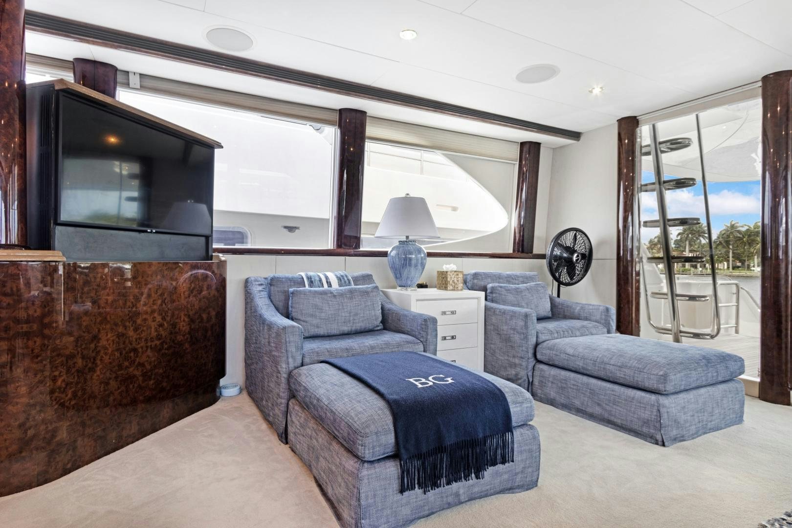 a living room with a blue couch aboard BELLA GIORNATA Yacht for Sale