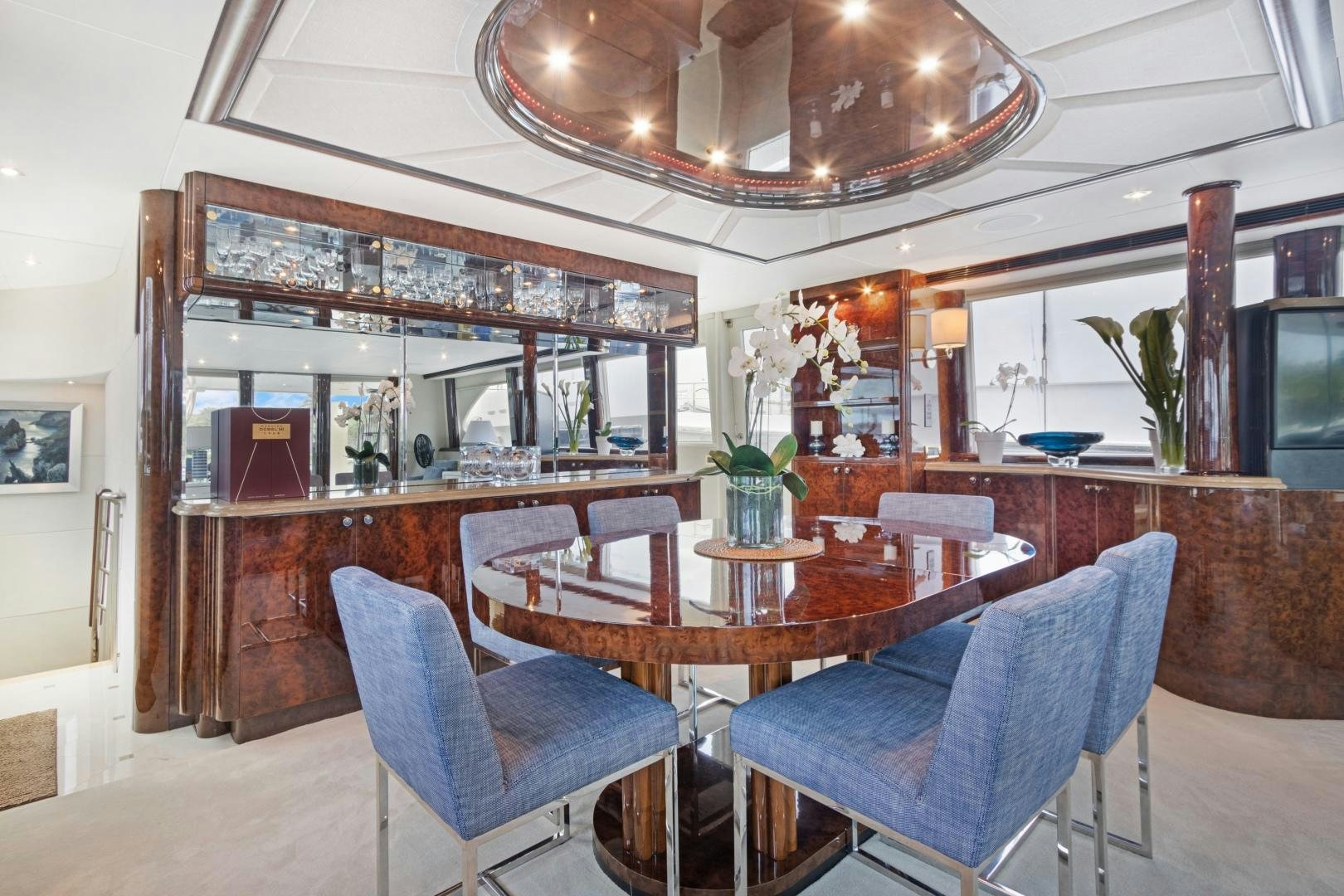 a room with a table chairs and a large mirror aboard BELLA GIORNATA Yacht for Sale