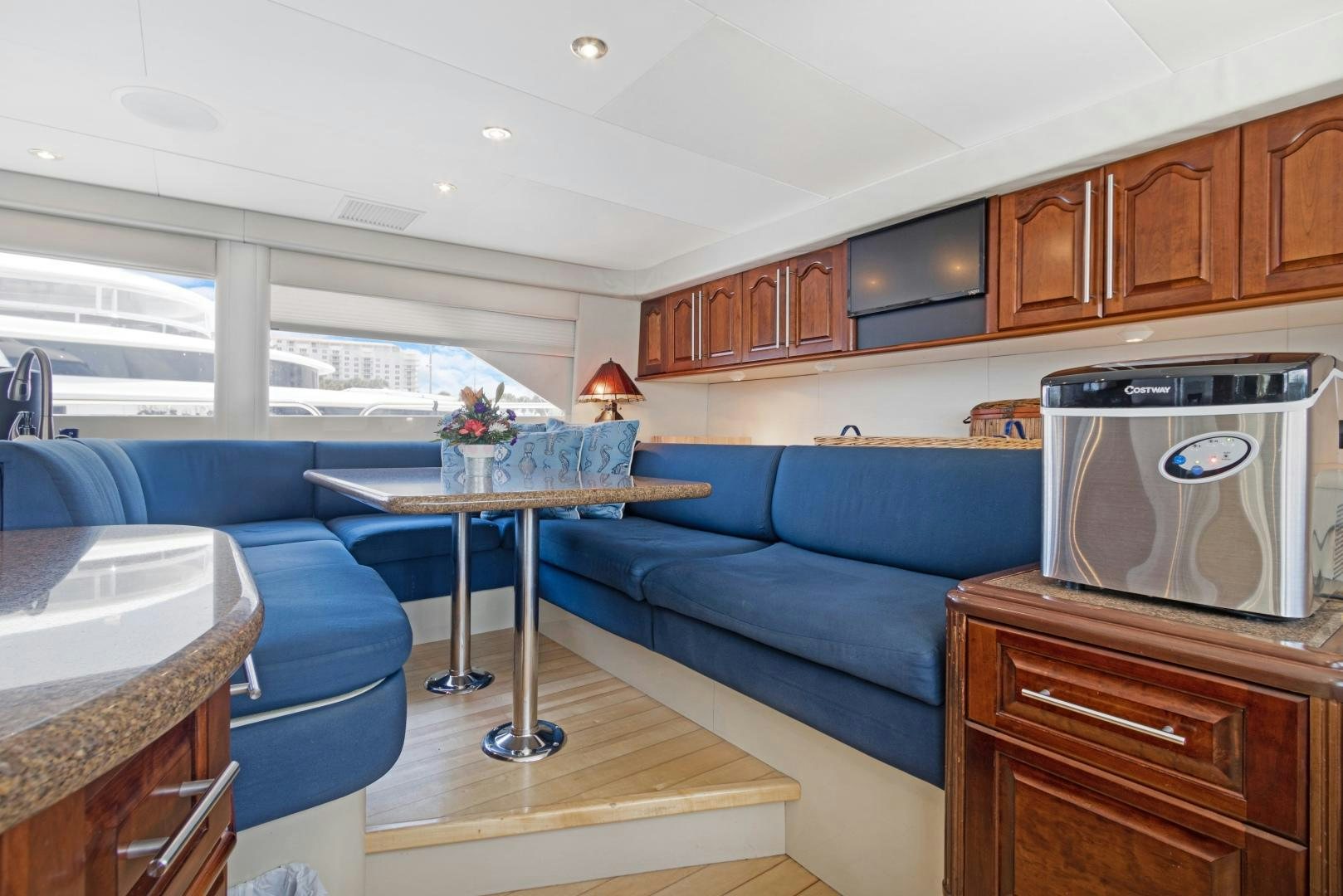 a living room with a couch and a table aboard BELLA GIORNATA Yacht for Sale