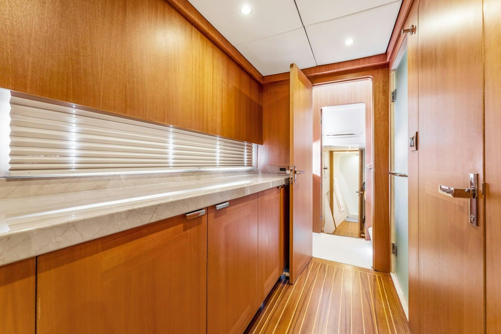 a room with wooden cabinets aboard No Name Yacht for Sale