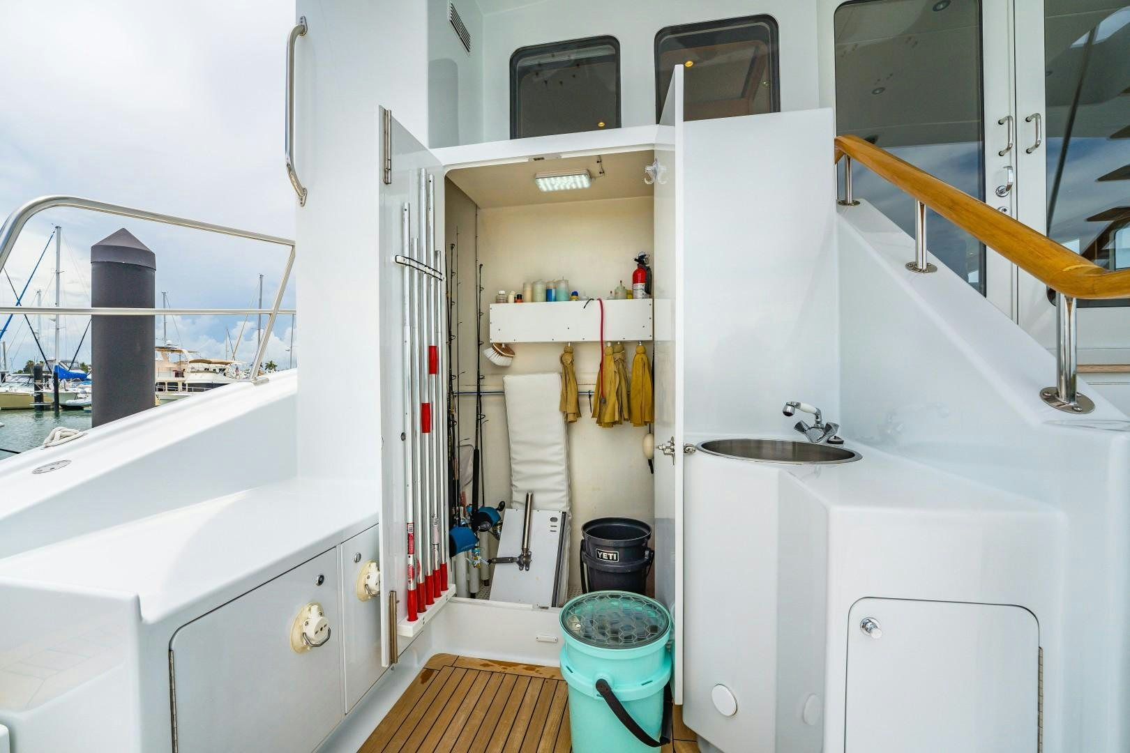 a room with a white cabinet and a sink and a large white shelf aboard No Name Yacht for Sale