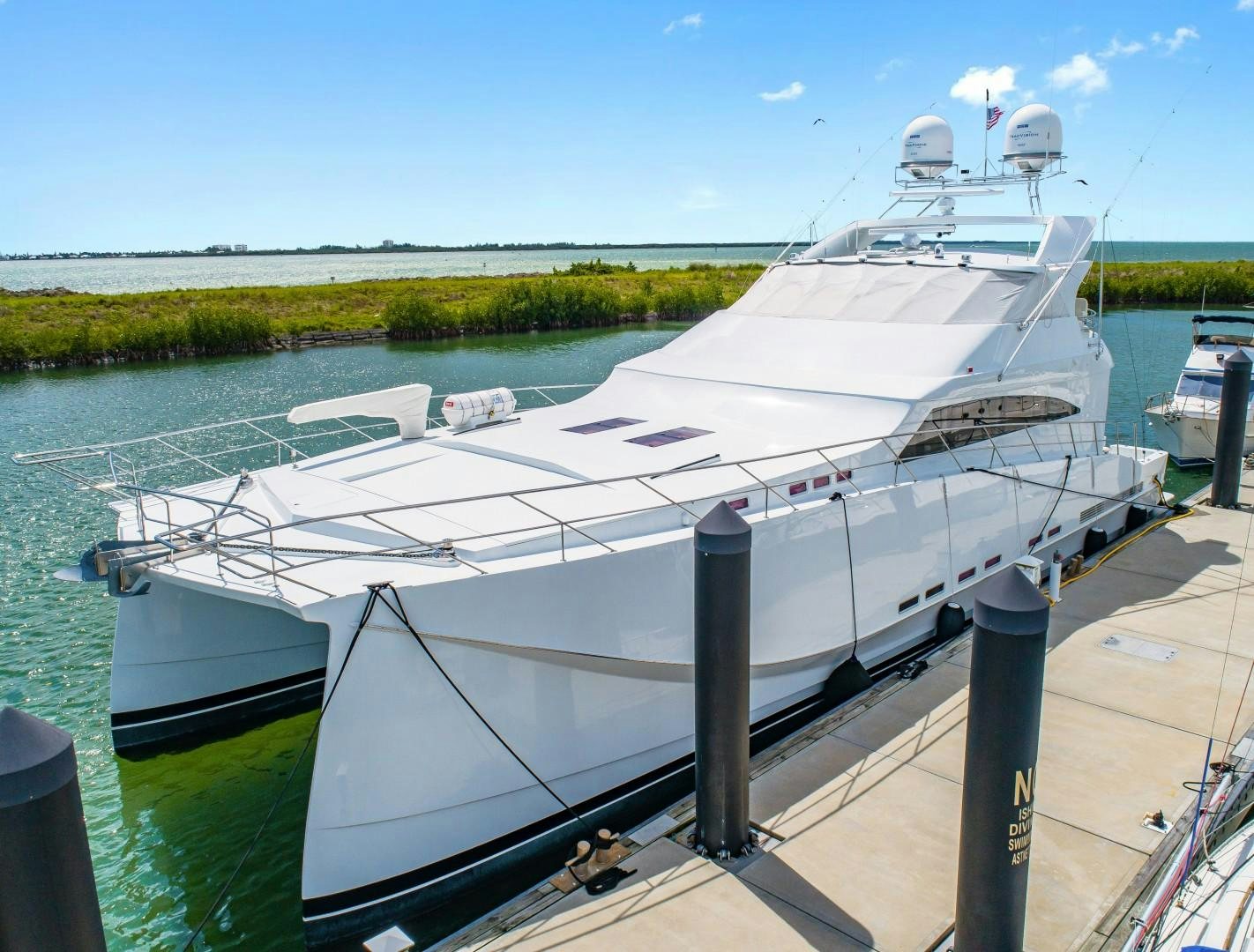 a large white boat docked aboard No Name Yacht for Sale