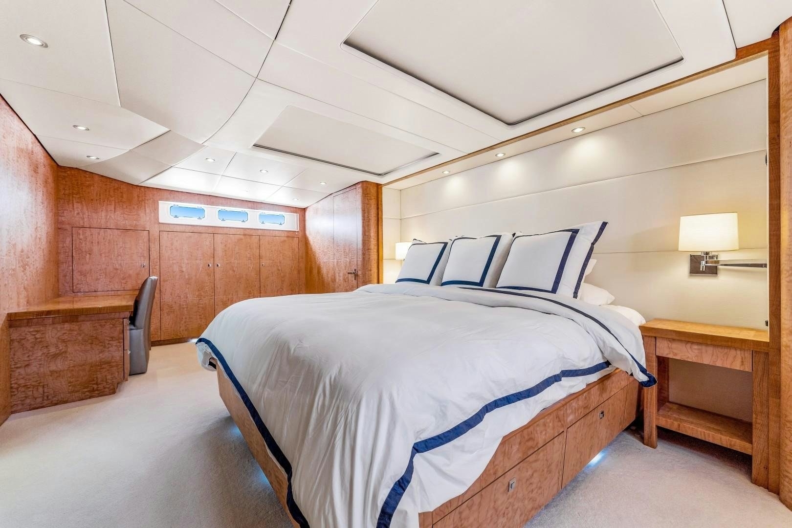 a bedroom with a bed and a desk aboard No Name Yacht for Sale