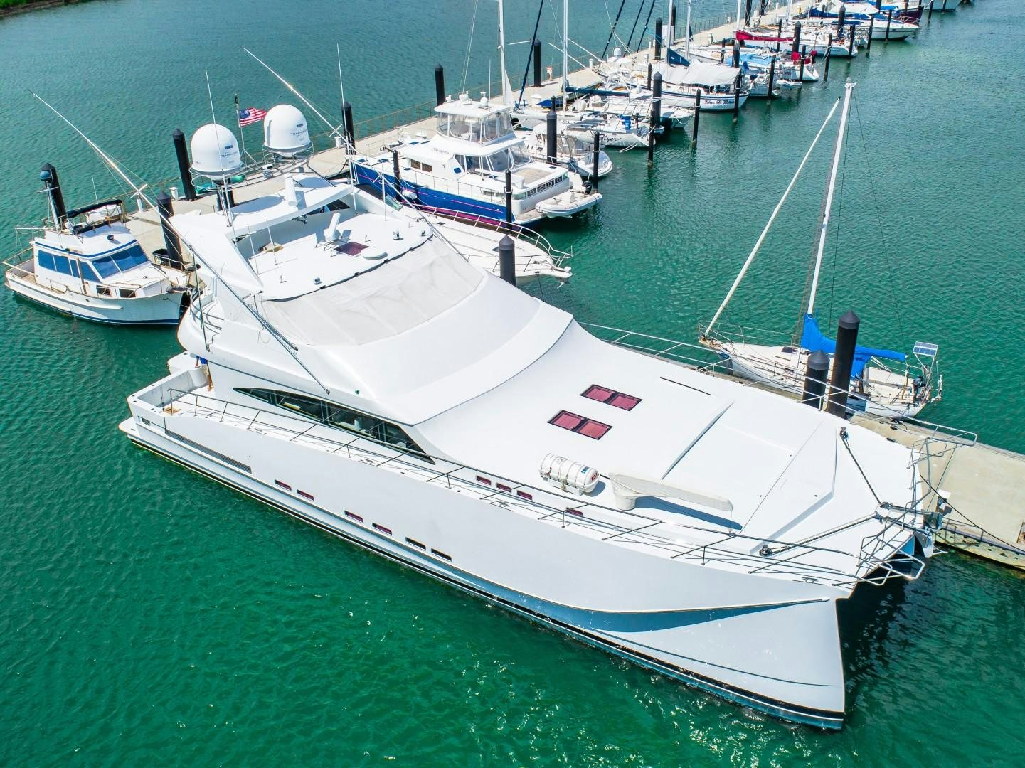 a large white boat sits in the water aboard No Name Yacht for Sale